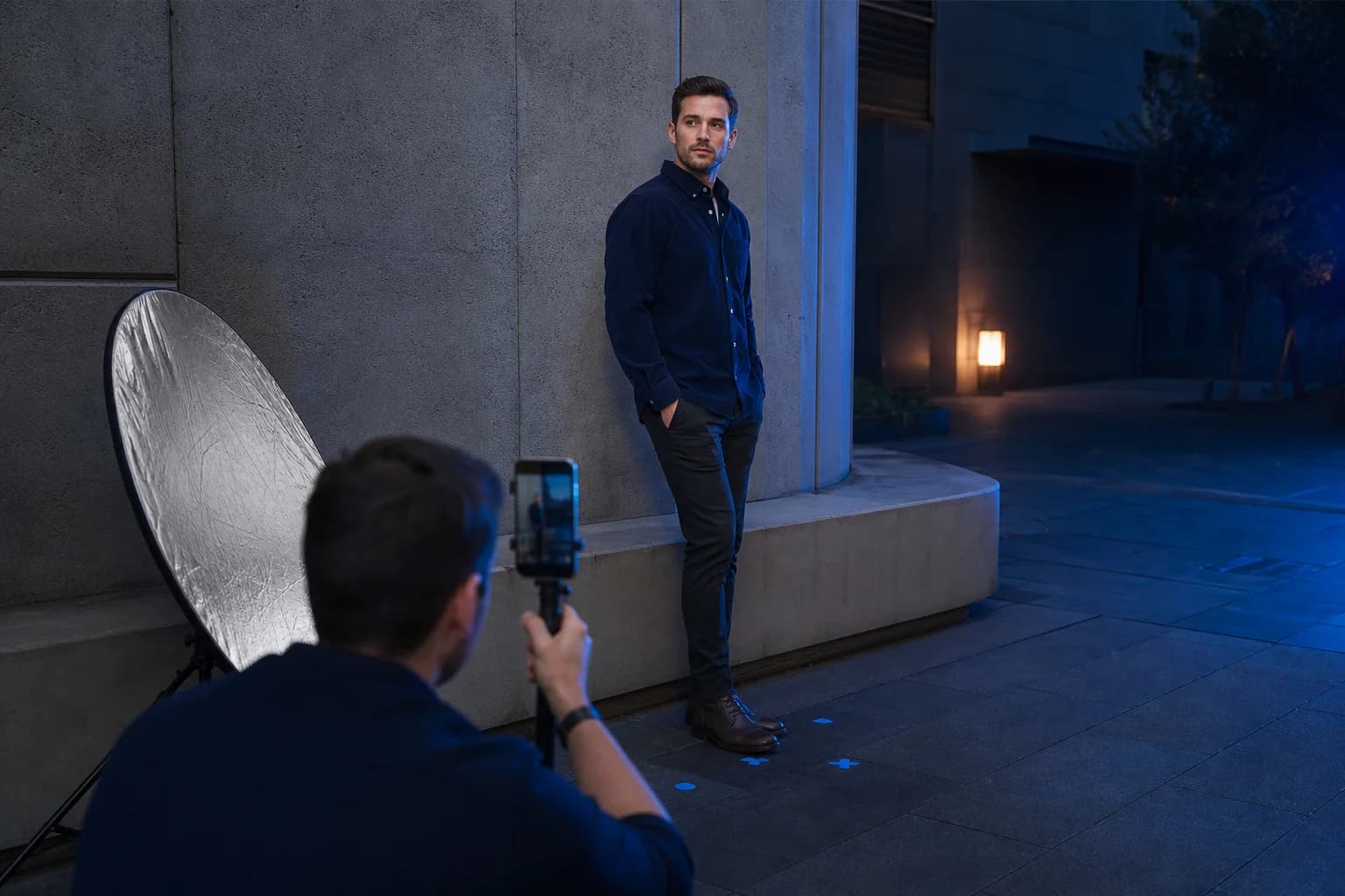 Man using camera distance, soft reflector light and floor marks during an outdoor portrait photo setup