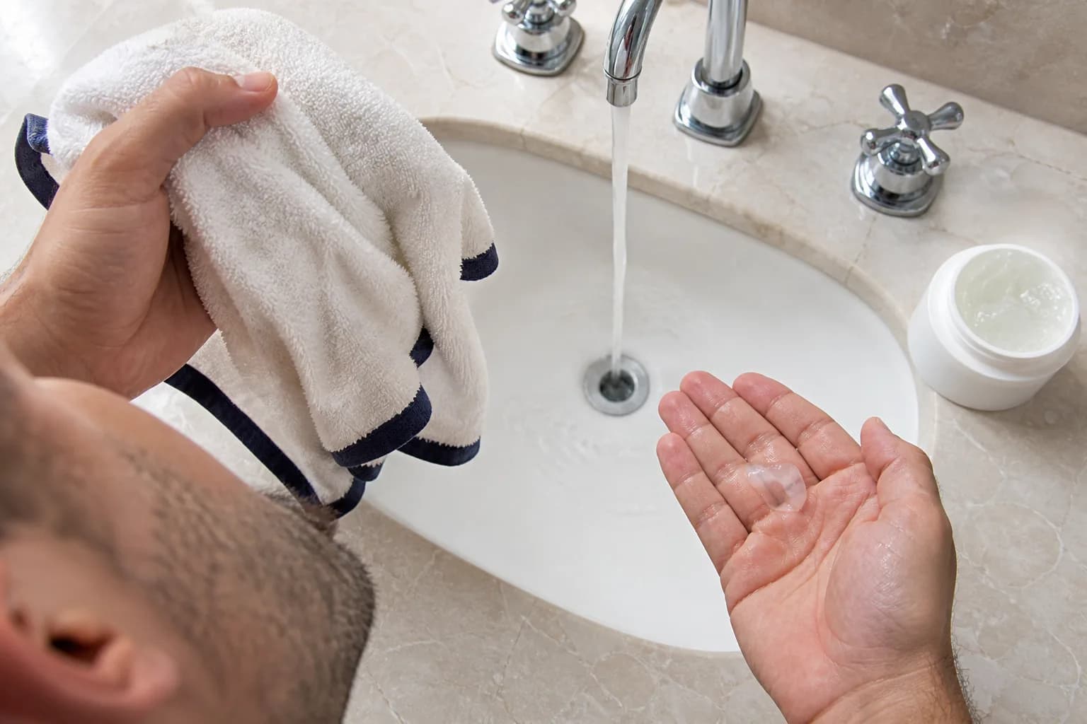 Adult man preparing short beard hair with a warm damp towel and clear shaving gel